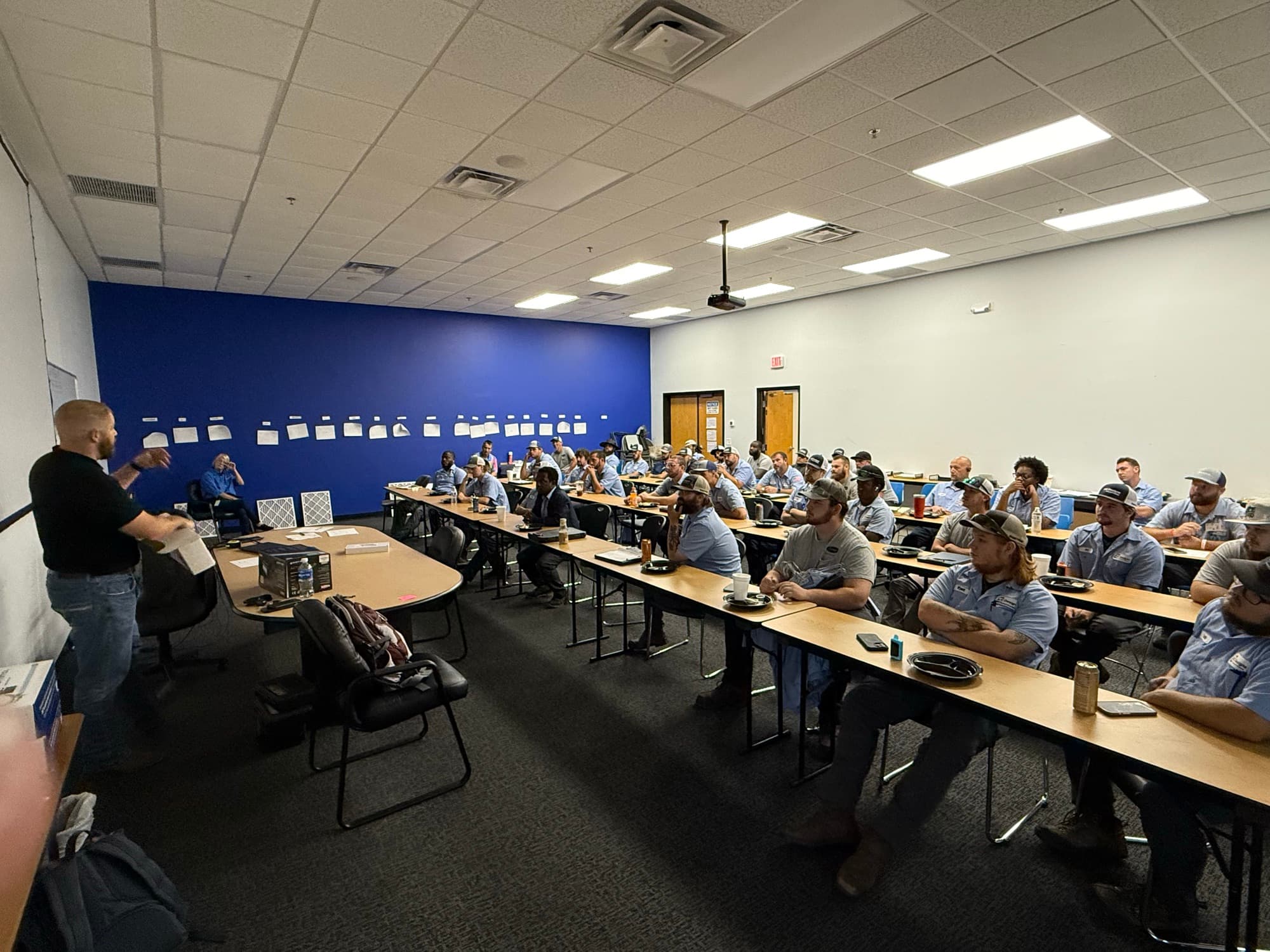 A full room of HVAC technicians at an AMP Strategic training session